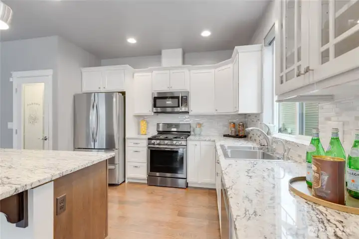 Vanity height cabinets and sleek stainless steel appliances.
