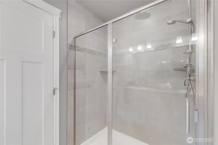 Primary: large glass enclosed shower.