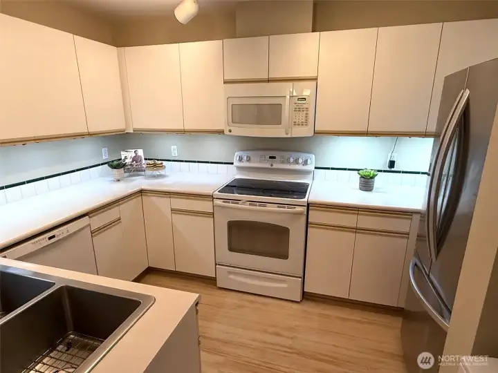 Kitchen offers loads of cabinet and counter space, deep double stainless sink, wave-activated under cabinet lighting and all appliances - how conveniet!