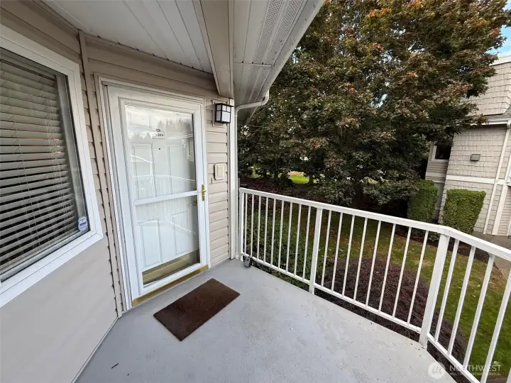 Covered entry deck has room to set a couple chairs out and enjoy the setting