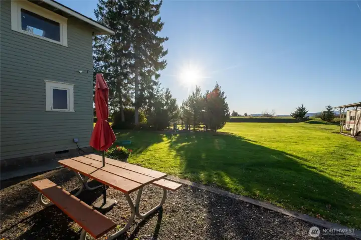 View to the west from back of home. Covered parking for RVs or Tractors on the right.