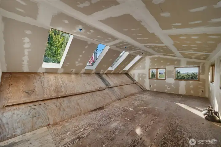 Large bonus room that was in the middle of being remodeled but now a blank canvas for you personal needs.  Windows in the backgound looking west towards the islands and bay.