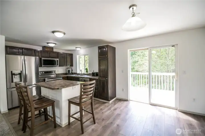 Bright and inviting kitchen featuring stainless steel appliances and a center island.