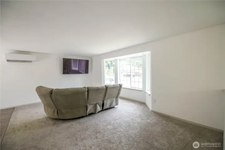 Roomy great room featuring large bay window brings in abundant natural light and a minisplit for efficient heating and cooling.