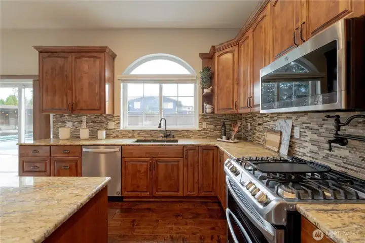 Gas appliances with pot filer above stove.