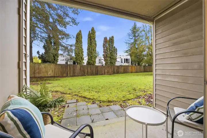 Private patio opening to an inviting grassy area