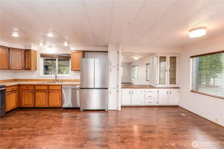Kitchen flowing into dining and living spaces
