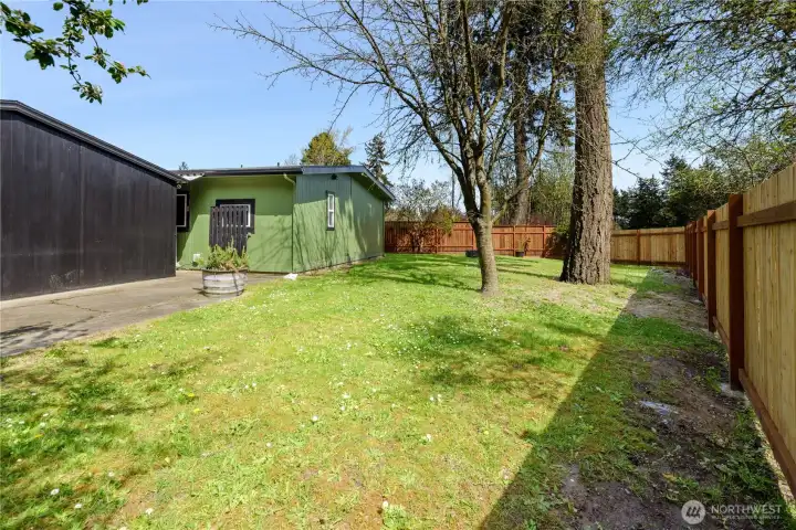 The large backyard and patio area, with an easy to maintain landscape or start creating your dream yard that is now fully fenced and enclosed for privacy!