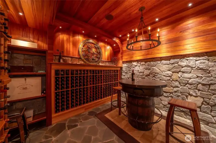 Temperature-controlled wine room with extensive storage and tasting space.
