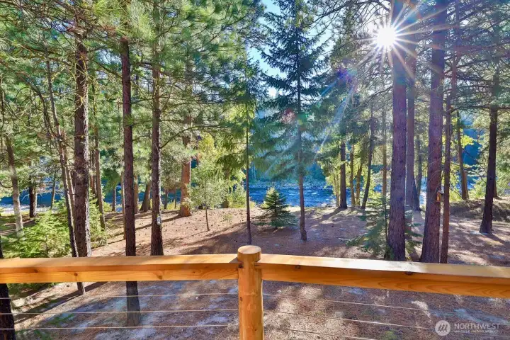 Peaceful riverfront setting surrounded by mature pines and natural beauty.