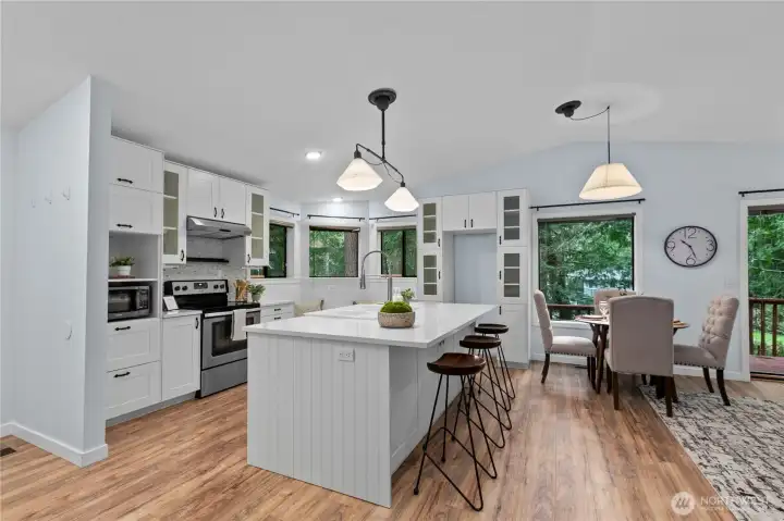 Large island, quartz countertops, and bar seating.