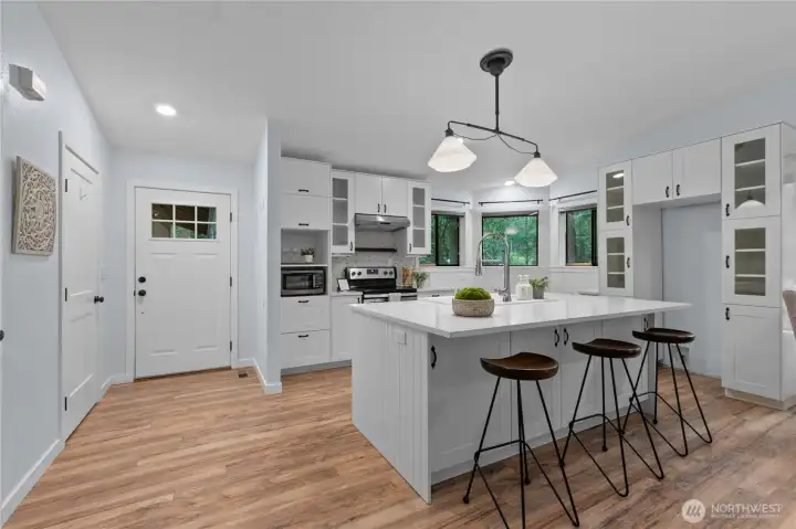 Stainless steel range, tile backsplash, and built-in cabinetry