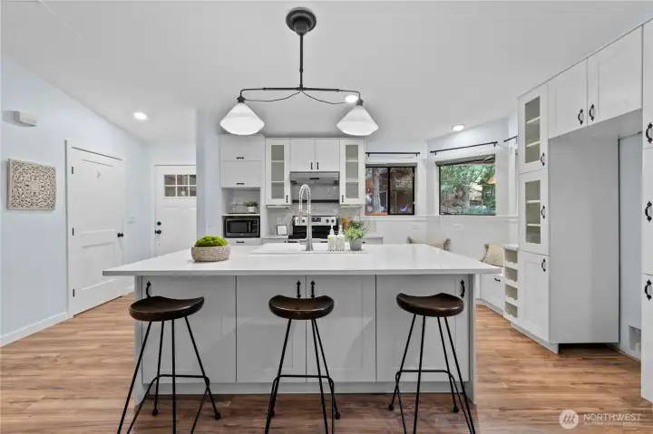Spacious kitchen island with pendant lighting and seating