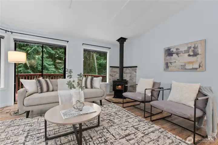 Living room with wood stove and access to deck