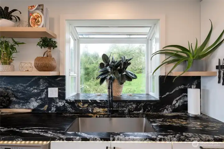 Charming Garden Window located right above the sink.