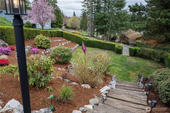 Enjoy the beauty of this terraced garden leading down to a private lawn area.