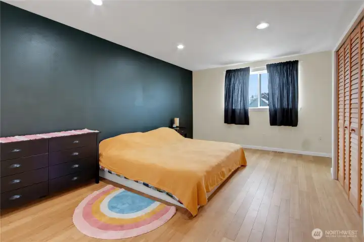 Primary bedroom offers plenty of space, natural wood closet doors and bamboo floors!