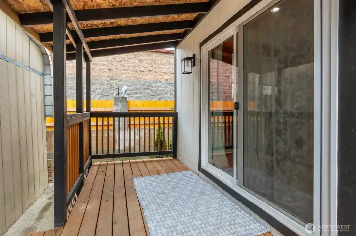 Covered back deck away from the weather and noise of the day, relax and unwind!