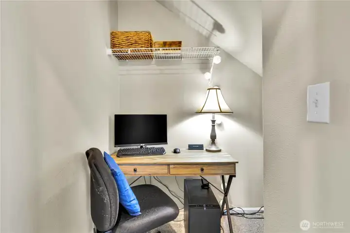 Seller utilized the spacious coat closet as a tucked away work station.