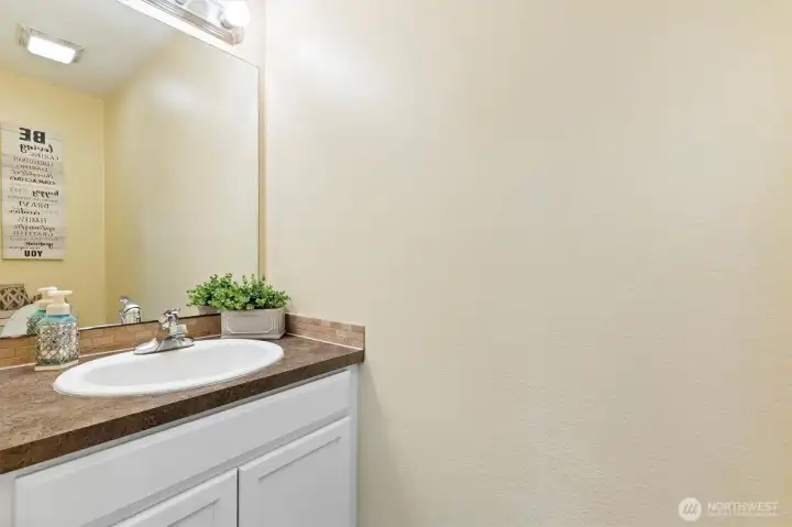 A half bath situated between the entrance to the garage and the kitchen.