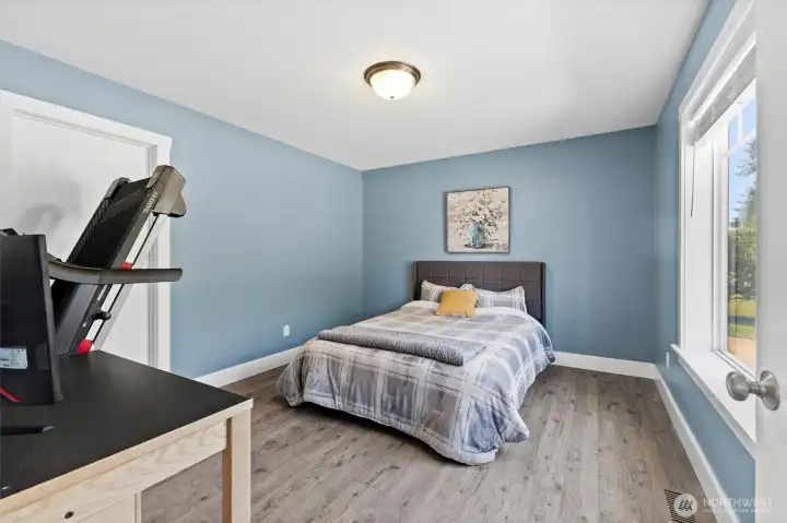 A main level bedroom or den, perfect for guests, a home office, or multi-generational living.