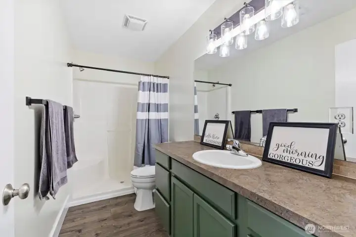 The ensuite bathroom is fresh, bright and well appointed.