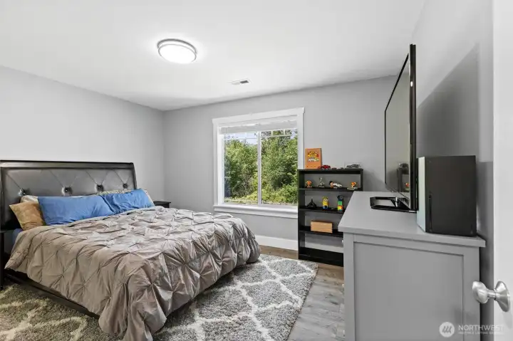 A generously sized second bedroom with peaceful views.
