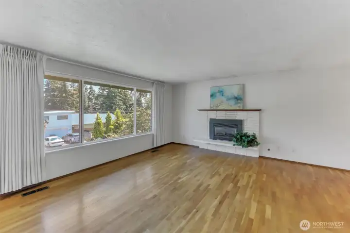 The living room is light and bright and features a gas fireplace.