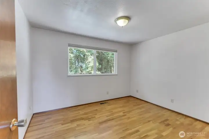 The second of 3 bedrooms is just across the hall from the primary bedroom.