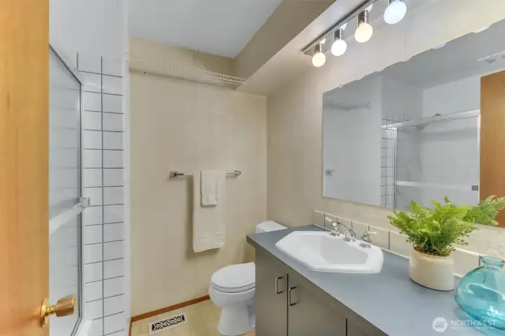 The hall bath features a tub shower combination and is just across from the 1st and 2nd bedrooms.