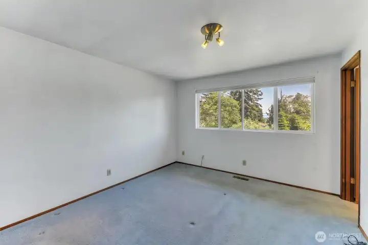 The primary bedroom has wall to wall carpet with original hardwood floors underneath.  You get to decide your preference.