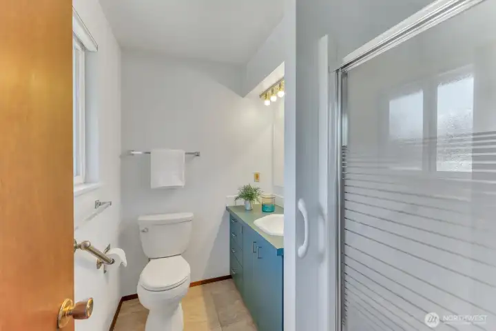 The primary is open and bright and features a comfortable shower.
