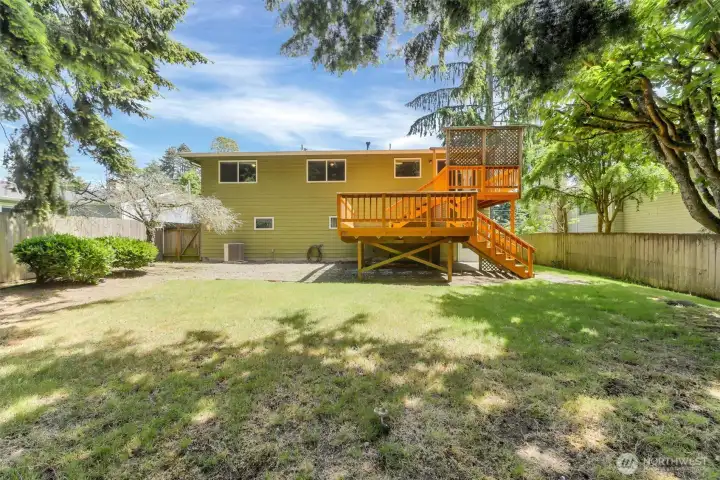 As well as being fully fenced the yard is level and open.  Notice the air conditioning unit near the rear of the home.