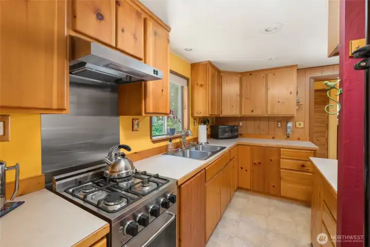 The efficient and functional kitchen includes a gas stove.