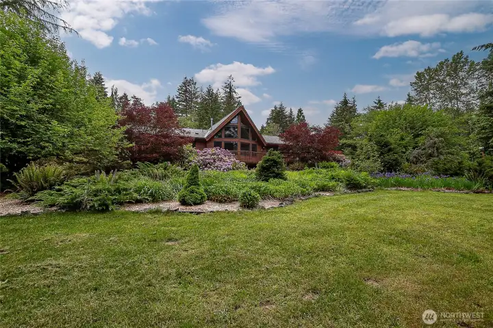 Back of the home overlooks masterfully planned gardens. Back of the home overlooks masterfully planned gardens.