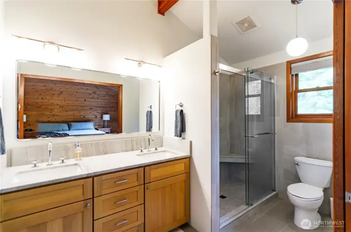 Remodeled primary bath has new rift-cut vanity with quartz counter tops. Over sized porcelin tiled shower Remodeled primary bath has new rift-cut vanity with quartz counter tops. Over sized porcelin tiled shower