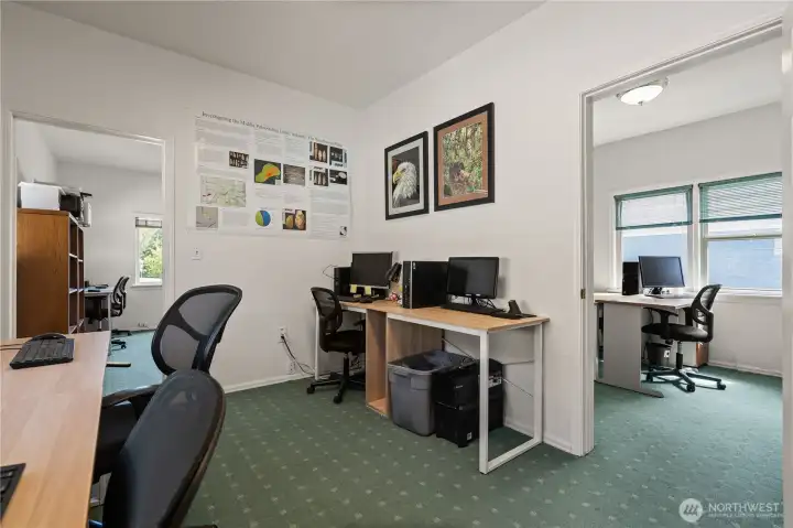 Additional office area offering flexible workspace options and connectivity between work areas.