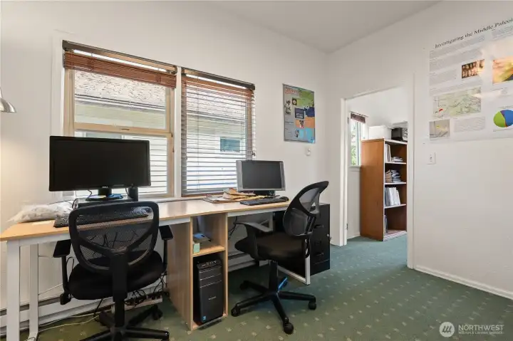 Additional office area with multiple workstations and flexible workspace configuration.