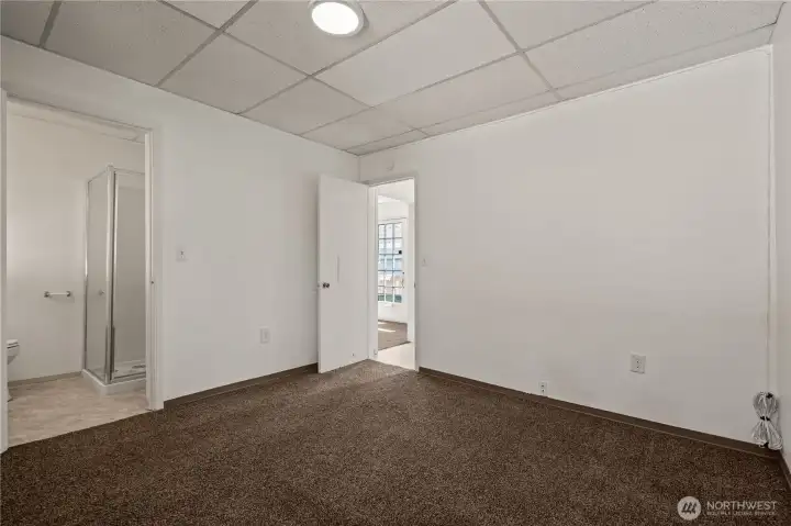 Spacious bedroom with adjoining bath access in the separate living unit.
