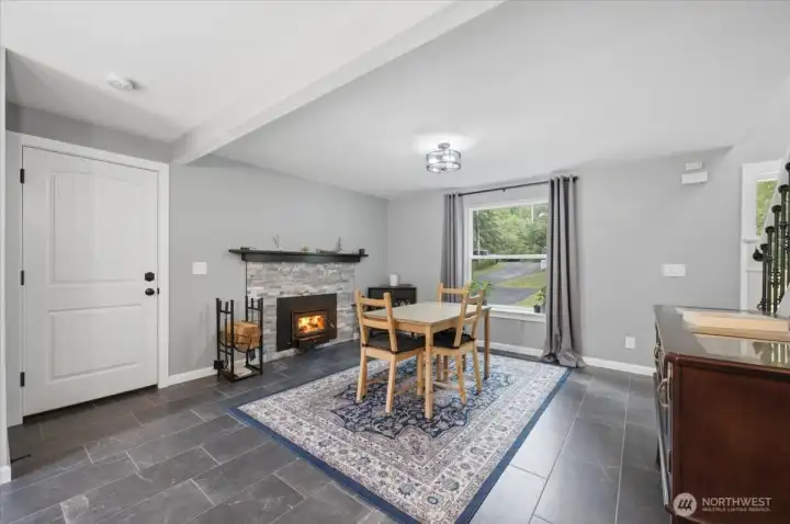 Family room with cozy fireplace! Thru the white door is the access to the garage
