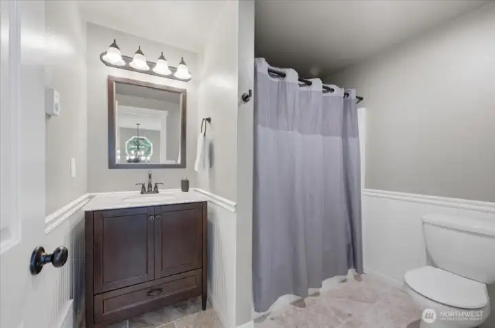 Full bathroom located on the upper level for use by Bedroom 2 and Bedroom 3