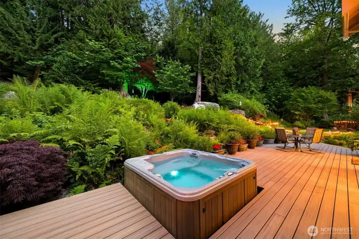 The brand-new composite deck creates a comfortable outdoor living space surrounded by gardens, mature landscaping, and forest. The hot tub and seating areas make this a natural place to unwind, entertain, or enjoy a quiet evening outdoors. The brand-new composite deck creates a comfortable outdoor living space surrounded by gardens, mature landscaping, and forest. The hot tub and seating areas make this a natural place to unwind, entertain, or enjoy a quiet evening outdoors.