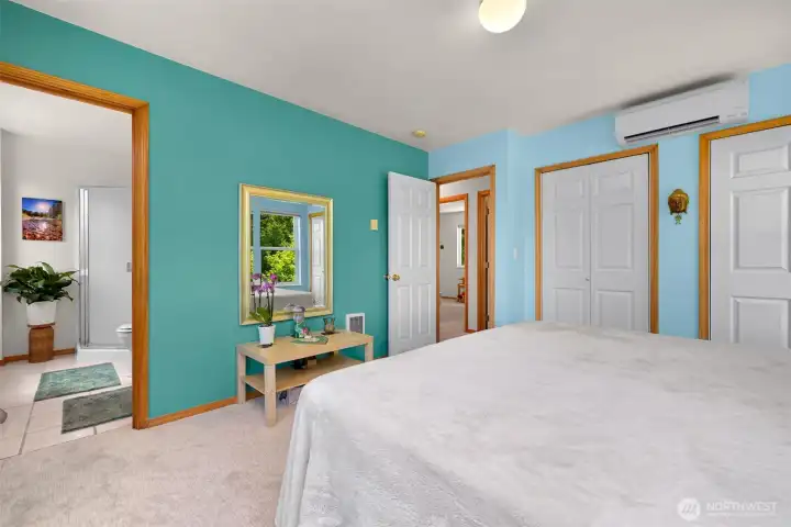 The primary suite includes a private bath, generous closet space, and a ductless mini-split for efficient year-round heating and cooling. Large windows bring in natural light and maintain the home's connection to the surrounding landscape. The primary suite includes a private bath, generous closet space, and a ductless mini-split for efficient year-round heating and cooling. Large windows bring in natural light and maintain the home's connection to the surrounding landscape.
