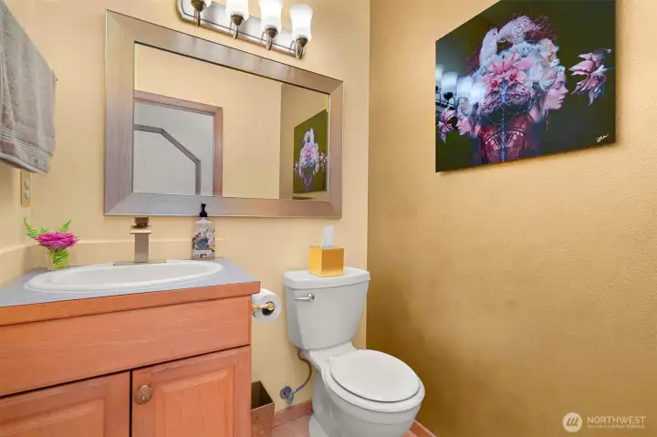 The main floor powder room provides convenient access for guests and day-to-day use, tucked just off the home's main living areas. Its central location makes it easily accessible from both the indoor and outdoor gathering spaces. The main floor powder room provides convenient access for guests and day-to-day use, tucked just off the home's main living areas. Its central location makes it easily accessible from both the indoor and outdoor gathering spaces.