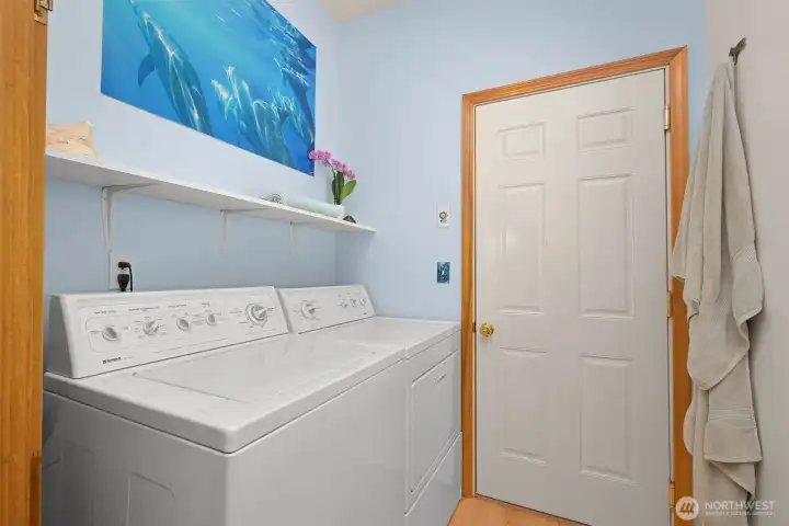 The dedicated laundry room provides additional storage and workspace while keeping everyday chores separate from the home's main living areas. Conveniently located on the main level, it's positioned near the garage and outdoor spaces for easy access. The dedicated laundry room provides additional storage and workspace while keeping everyday chores separate from the home's main living areas. Conveniently located on the main level, it's positioned near the garage and outdoor spaces for easy access.