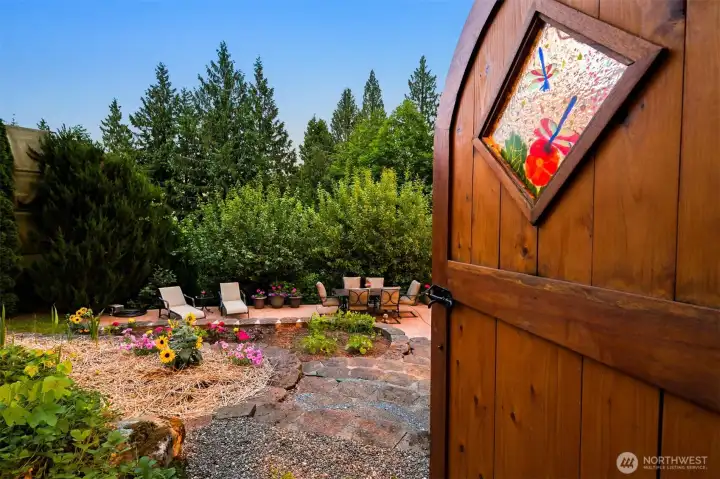 A handcrafted gate opens into one of the property's central outdoor gathering spaces, surrounded by gardens, patios, and mature landscaping. Throughout Forest Haven, pathways and garden rooms create a sense of exploration that unfolds as you move through the landscape. A handcrafted gate opens into one of the property's central outdoor gathering spaces, surrounded by gardens, patios, and mature landscaping. Throughout Forest Haven, pathways and garden rooms create a sense of exploration that unfolds as you move through the landscape.