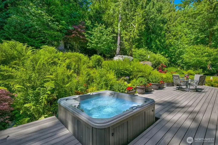 The hot tub is set into the new composite deck and surrounded by mature gardens, creating a private place to relax at the end of the day. From here, you're immersed in the landscape, with forest, birdsong, and greenery in every direction. The hot tub is set into the new composite deck and surrounded by mature gardens, creating a private place to relax at the end of the day. From here, you're immersed in the landscape, with forest, birdsong, and greenery in every direction.