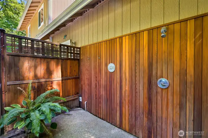 The custom outdoor shower is tucked beside the deck and gardens, providing a convenient place to rinse off after gardening, hiking, swimming, or a soak in the hot tub. It's one of many thoughtful features that reinforces the property's connection to outdoor living. The custom outdoor shower is tucked beside the deck and gardens, providing a convenient place to rinse off after gardening, hiking, swimming, or a soak in the hot tub. It's one of many thoughtful features that reinforces the property's connection to outdoor living.