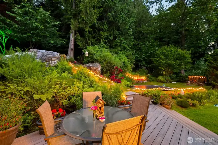 Looking out from the deck, you'll find layers of gardens, pathways, gathering spaces, and forest that make the property feel much larger than its footprint suggests. The landscape was thoughtfully developed over many years to create a series of outdoor rooms connected by trails and garden paths. Looking out from the deck, you'll find layers of gardens, pathways, gathering spaces, and forest that make the property feel much larger than its footprint suggests. The landscape was thoughtfully developed over many years to create a series of outdoor rooms connected by trails and garden paths.