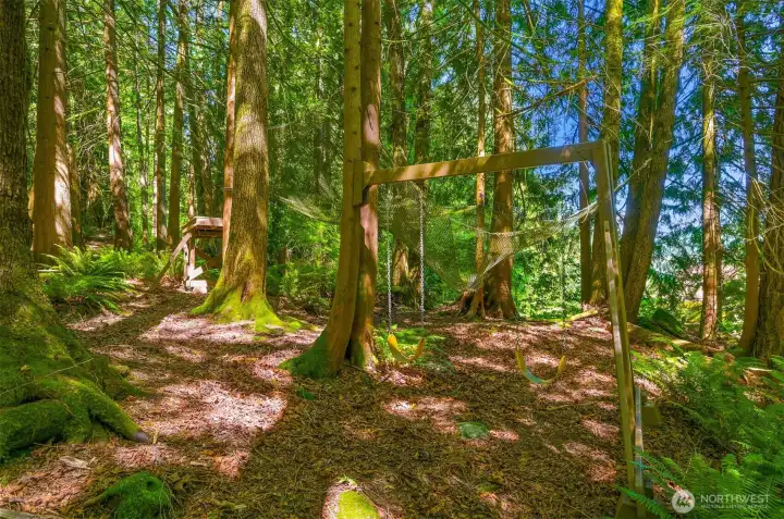 Beyond the gardens and lawn, the forest becomes an extension of the property itself, with play areas, swings, trails, and gathering spaces tucked among the trees. Unlike many wooded properties, the terrain here is remarkably usable, making it easy to explore and enjoy the forest on a daily basis. Beyond the gardens and lawn, the forest becomes an extension of the property itself, with play areas, swings, trails, and gathering spaces tucked among the trees. Unlike many wooded properties, the terrain here is remarkably usable, making it easy to explore and enjoy the forest on a daily basis.